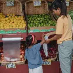 Foster mother and foster child shopping in a market